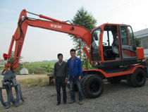 Wheeled Excavator With Log Grapple And Wood Clamp