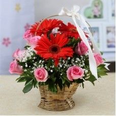 Red And Pink Flowers Arranged In Round Basket