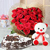 दिल के आकार का ब्लैक फ़ॉरेस्ट केक और लाल गुलाब एक टेडी बियर के साथ