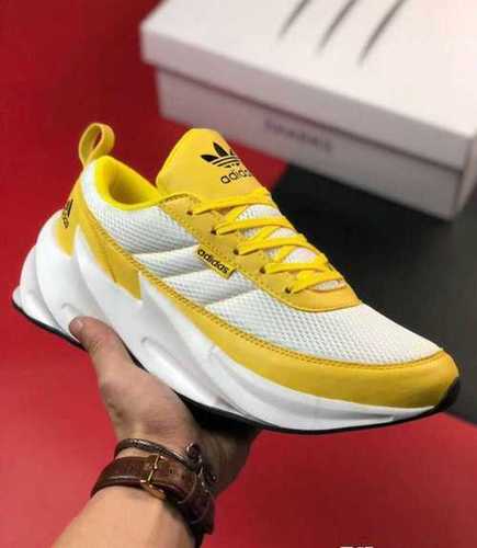 white and yellow adidas shoes