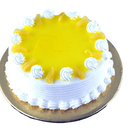 Eggless Pineapple Cake, Good Quality, Fresh, Pure And Hygienic, Delicious And Yummy Taste, Mouthwatering Flavors, Pleasing Aroma, Free From Impurities, Round Shape, Yellow And White Color