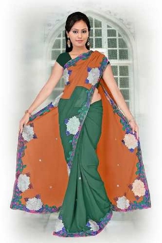 स्प्रिंग ग्रीन और ऑरेंज (नारंगी) कैज़ुअल वियर स्किन फ्रेंडली महिलाओं के लिए फैंसी प्लेन इंडियन साड़ी