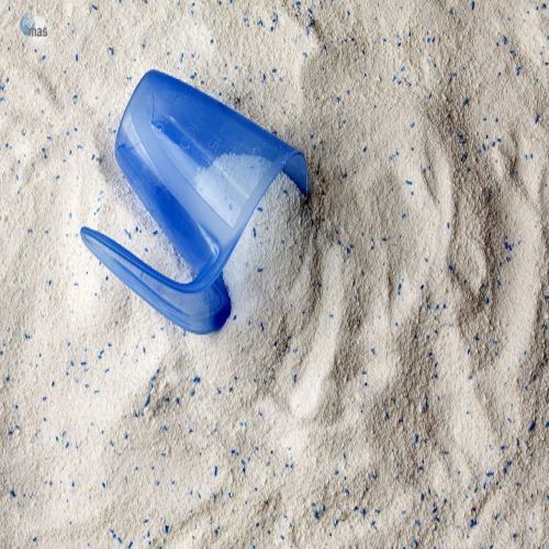Washing laundry detergent powder and blue plastic measuring cup